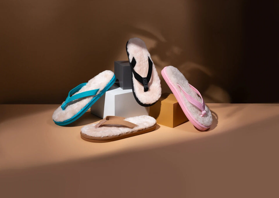 Black, blue, brown, and pink Bonsai sheepskin sandals arranged together